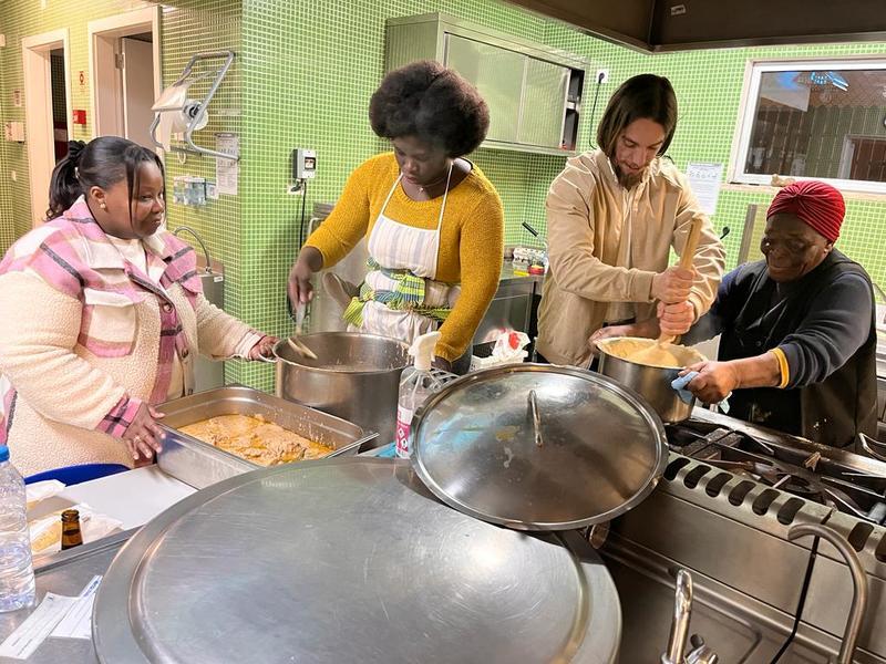 Four women cooking in a friendly and learning environment 