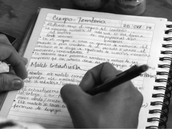 Person taking detailed notes in a notebook